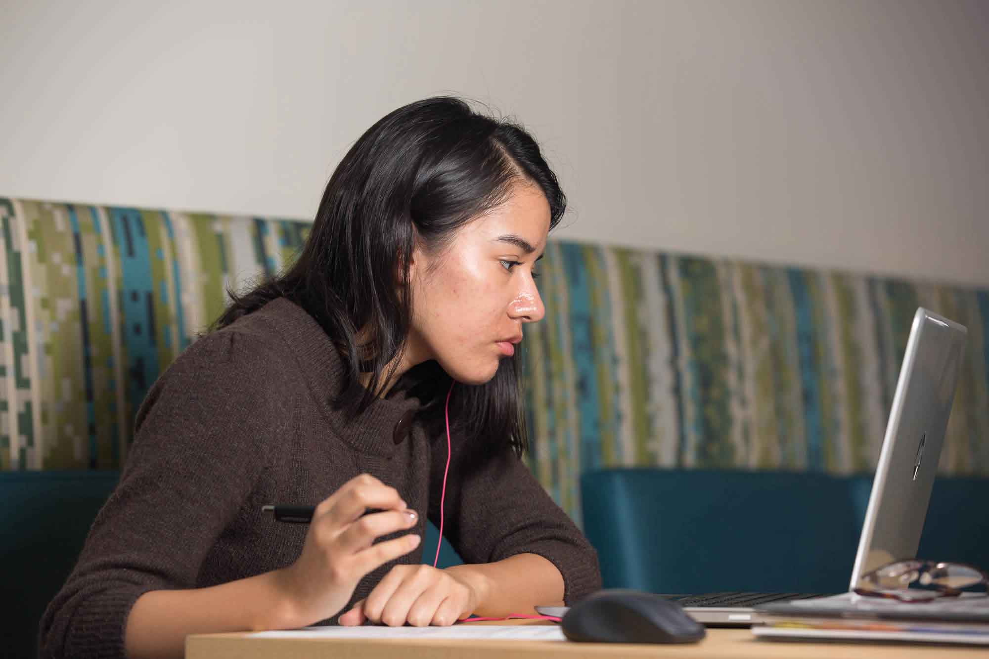 A student working on an assignment on her laptop